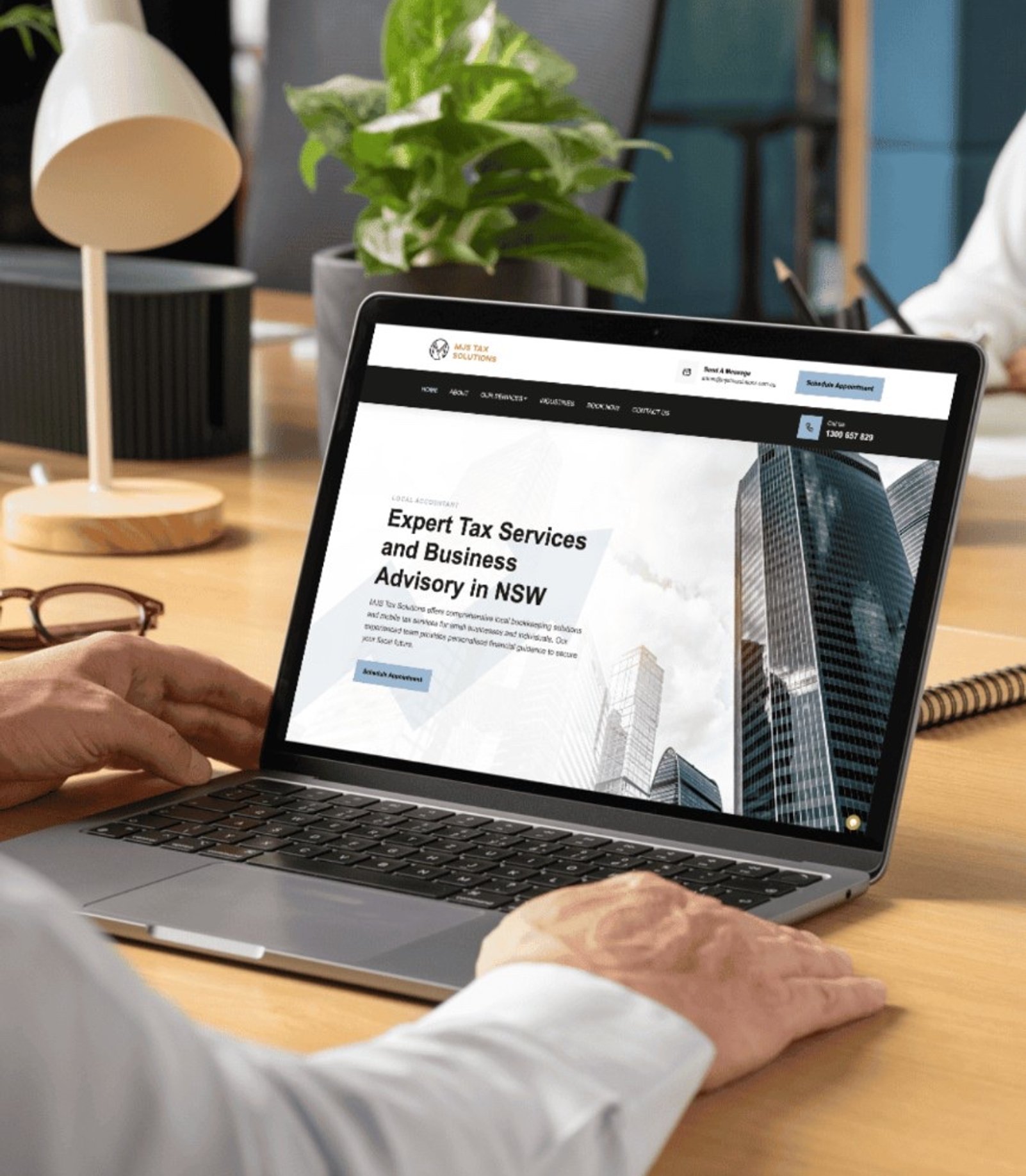 MJS Tax Solutions website displayed on a laptop
